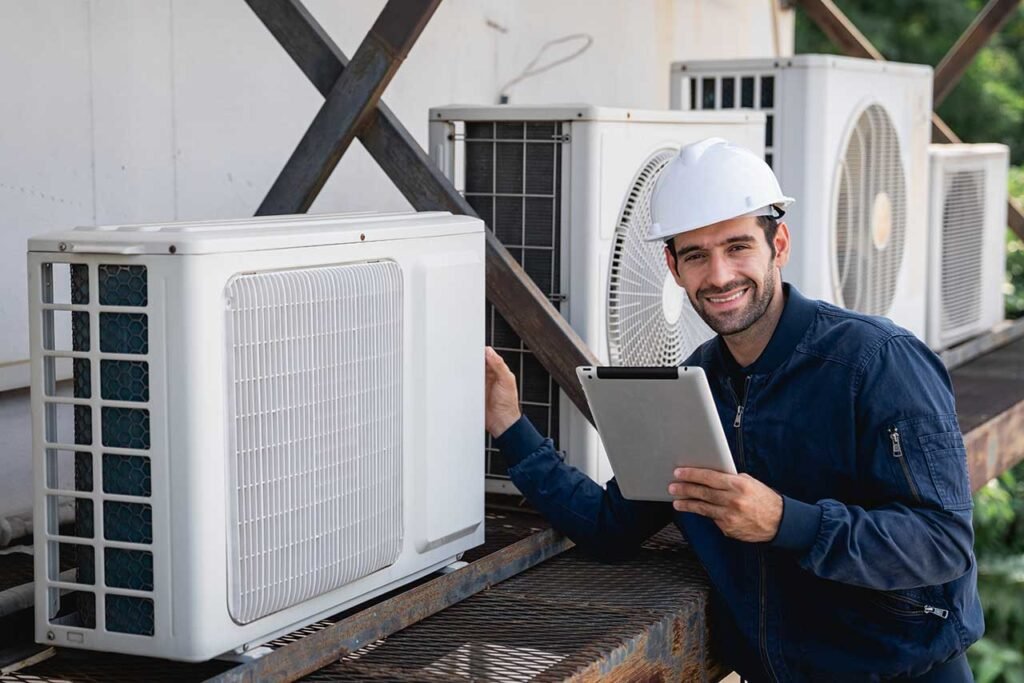 Professional technician installing a modern wall-mounted air conditioning unit in a residential property in London.