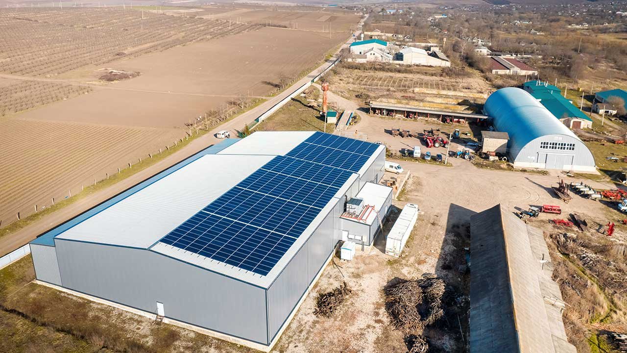 Commercial solar panel installation on the rooftop of a business building in London, with technicians installing photovoltaic panels for clean and efficient energy generation.